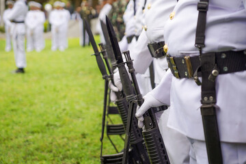 Soldiers in White Uniforms Holding Bayonet Rifles During Ceremonial Formation