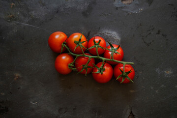 Bunch of vine ripened tomatoes on black background