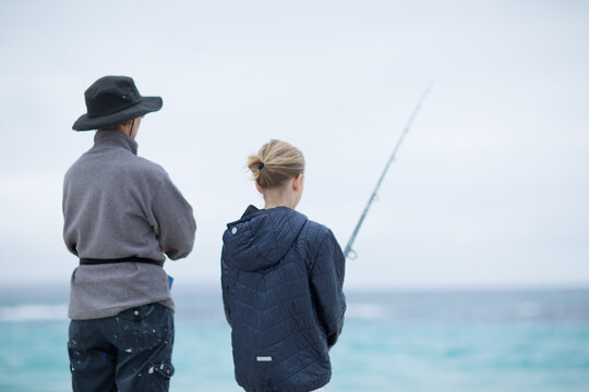 Woman and child fishing in the ocean