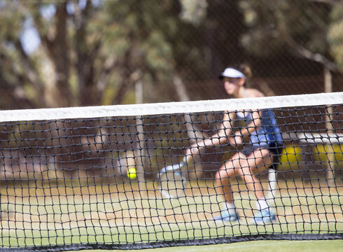 Female tennis player hitting ball