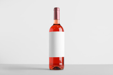 Bottle of wine with blank label on table against white background