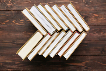 Many different books on wooden background, top view