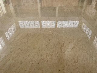 Rows of electrical sockets, white electrical switches on a luxurious glossy brown marble wall