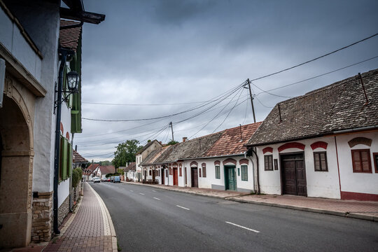 Baross Gabor Utca street, the main street of Villany with wineries and wine cellars during a cloudy afternoon. Villany is a village of southern hungary known for wine.