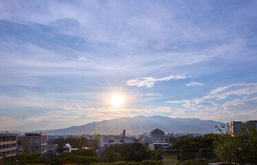 Evening sunset mountain view and clouds over the city
