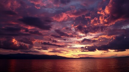 Fototapeta premium Fiery Sunset Cloudscape Over Calm Water