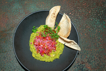 Guacamole with Nachos and Red Onion..