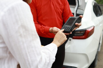 A confident businesswoman carries a cardboard package indoors, representing e-business, delivery service, entrepreneurship, and small business success.
