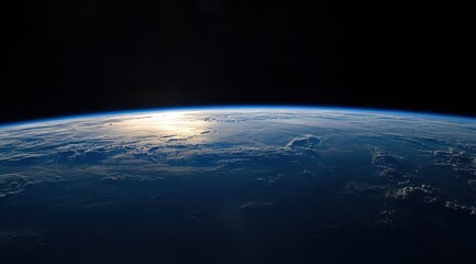 Stunning sunrise view of Earth from space, showing the curvature and atmospheric glow