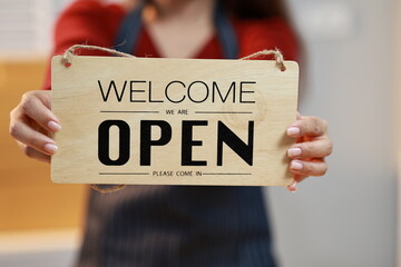 A happy adult opening a delivered package indoors, expressing excitement and...