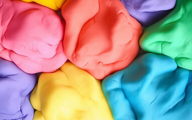Close up of several lumps of colorful modeling clay in various bright shades