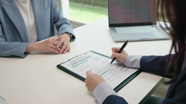 Asian female audit ESG risk check list paper form net zero waste supply chain vendor eco go green carbon credit control. Asia people woman give advice report prepare work review best practice process.
