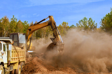 Heavy machinery clears soil tree removal, at construction site, creating dust cloud work in progress deforestation