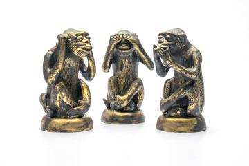 Three monkey dolls, ears closed, eyes closed, mouth closed, on a white background