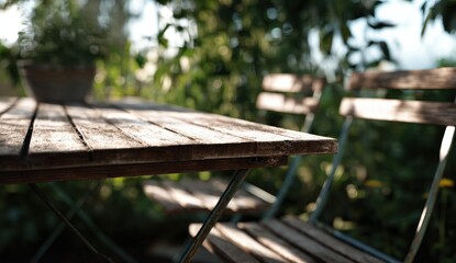 Naklejka premium Wooden table and chairs in a garden setting with lush greenery.