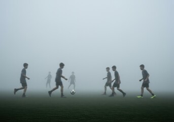 Soccer players silhouette foggy field