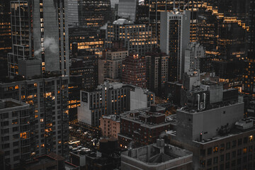 Nighttime New York City Skyline With Bright Urban Lights Across Tall Buildings and Rooftops
