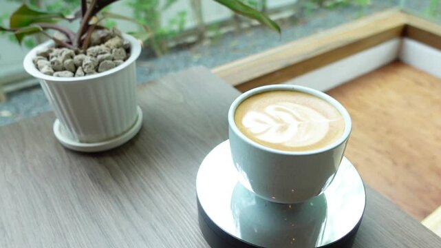 Barista Pouring Latte Art &ndash; Creating Rosetta Pattern in Cappuccino Cup, forming a beautiful latte art design. Ideal for coffee ads, tutorials, and aesthetic visuals.