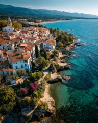 Obraz premium Aerial view of a charming Mediterranean coastal town, red rooftops, blue sea, sunlit buildings, winding streets, summer holiday vibe