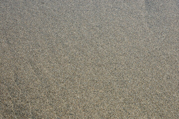 Close-up Wet Sand Texture on Iwama Beach, Iwaki City, Fukushima Prefecture, Japan – Natural Background for Travel, Tourism, Nature, Design, Copy Space and Relaxation Concepts

