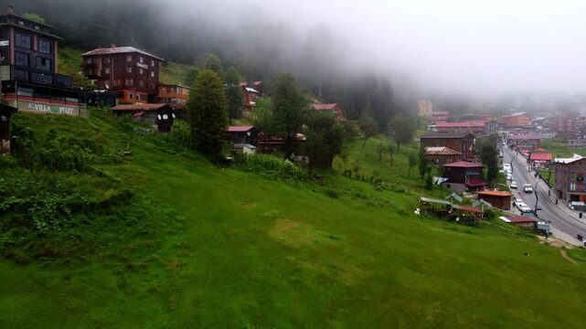 Aerial: Drone Forward Scenic Shot Of Houses On Green Mountain Under Cloudy Sky - Ayder, T�rkiye