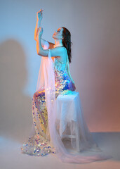 Fantasy studio portrait of a red-haired mermaid faery model wearing a white pearl gown, fairytale...
