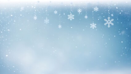 Fototapeta premium Beautiful winter background with delicate snowflakes falling against a soft blue backdrop design.