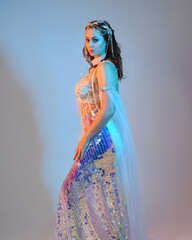Fantasy studio portrait of a red-haired mermaid faery model wearing a white pearl gown, fairytale...