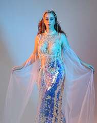 Fantasy studio portrait of a red-haired mermaid faery model wearing a white pearl gown, fairytale...