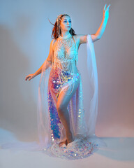 Fantasy studio portrait of a red-haired mermaid faery model wearing a white pearl gown, fairytale...
