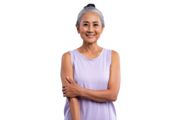 Smiling senior woman in lavender top standing with arm across body, PNG