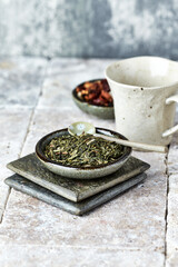 Dried Green Tea Leaves on Bright Background. Close up.