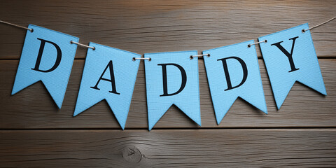 Light blue banner with the word "DADDY" on a wooden background, bunting for Father's Day.
