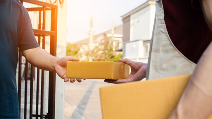 Service and delivery concept. Delivery man holding an empty parcel box The courier delivers the...