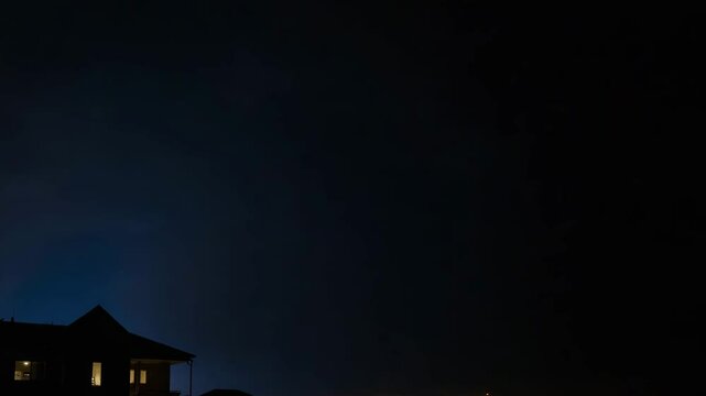 Lightning rod during a thunderstorm near a house at night  