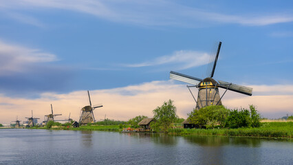 Rows of Historic wind mills at UNESCO world heritage site Kinderdijk in the Netherlands during springtime.