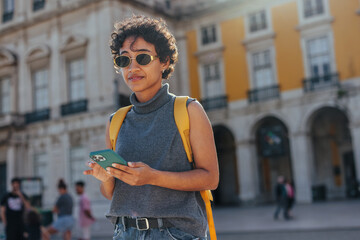 Young tourist using a smart phone in lisbon, portugal