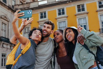 Happy tourists taking photo of themselves in lisbon, portugal