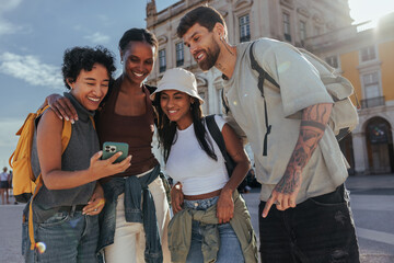 Tourists using smart phone and enjoying vacation in lisbon, portugal