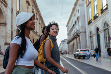 Tourists walking down street in lisbon, portugal, exploring city center