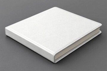 Close up of a closed white leather book on a gray background