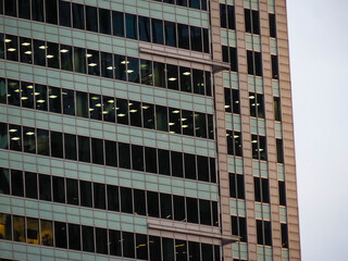 Modern Glass Office Building Reflecting Urban Skyline at Dusk in Warsaw's Business District