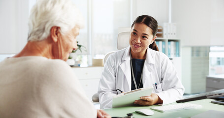 Fototapeta na wymiar Senior woman, happy doctor and consultation with clipboard for healthcare report, symptoms or checkup. Medical professional, appointment and talking to patient for help or writing results in hospital