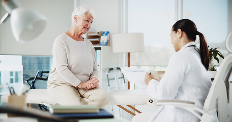Writing, doctor and consulting with old woman in office for patient records, insurance and...