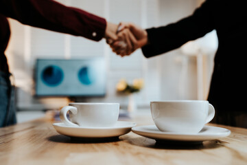 Young adults enjoy coffee and conversation at a cozy café, sharing laughter, bonding, and relaxation in a warm, friendly atmosphere indoors.