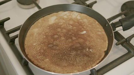 The delightful Golden Pancake Cooking on a classic Stove Top for a perfect breakfast experience