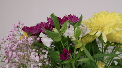This is a stunning and beautiful floral arrangement featuring vibrant yellow and purple flowers