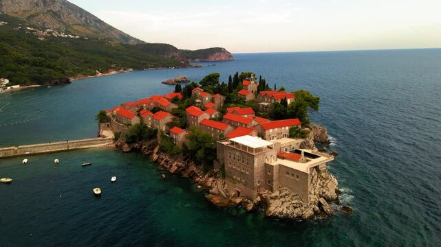 Aerial Panning Shot Of Aman Sveti Stefan Hotel By Residential Town On Sea - Budva, Montenegro