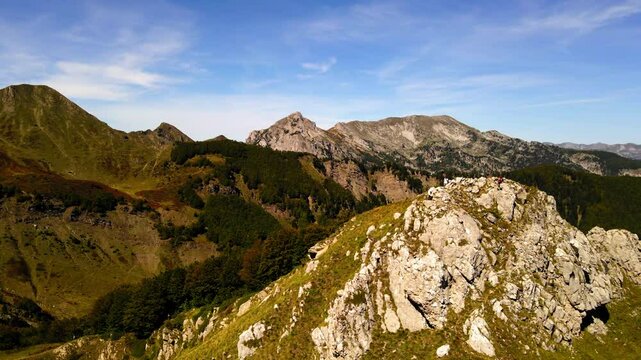 Aerial Panning Shot Of Tourists On Top Of Tranquil Mountain During Hiking Adventure - Plav, Montenegro