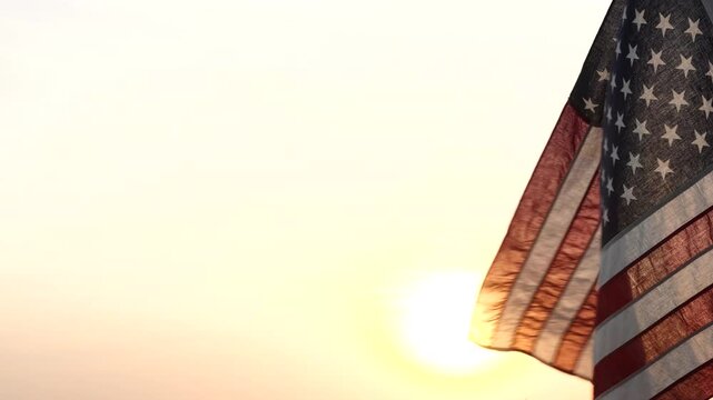 Fourth of July. Silhouettes of American flag waving on background of beautiful sunset or sunrise for honoring, mourning USA military. 4th of July, Memorial Day, Happy Holiday American Concept